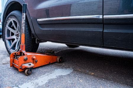 A car with a hydraulic jack 