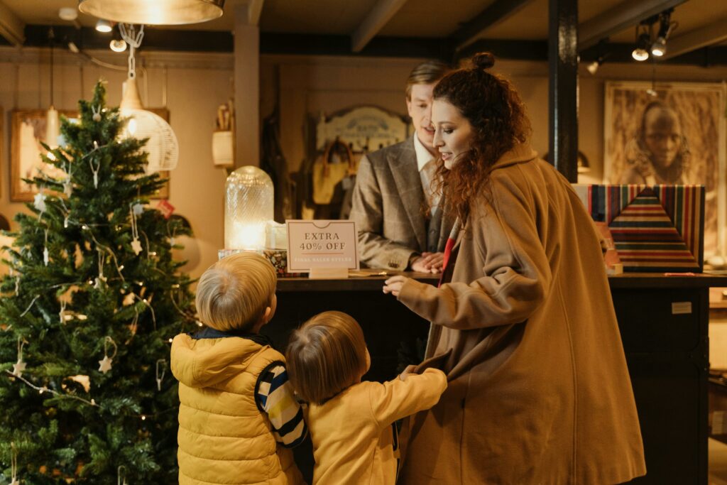 A woman and her two sons shopping at a checkout