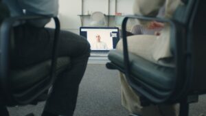 People sitting in a chair getting online counseling 