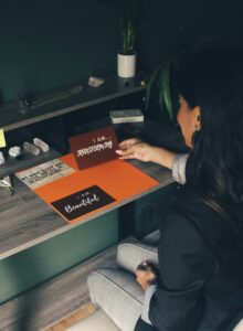 A woman sitting on a desk with positive affirmations 