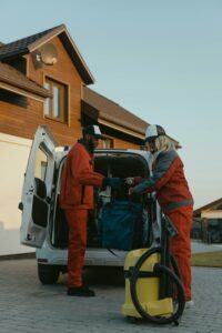 A professional cleaning crew behind a white van 